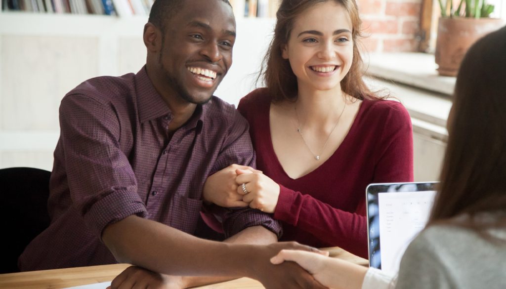 Couple talking to a real estate agent